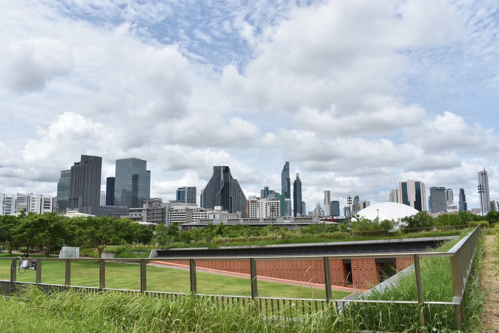 a city skyline with a fence and grass field