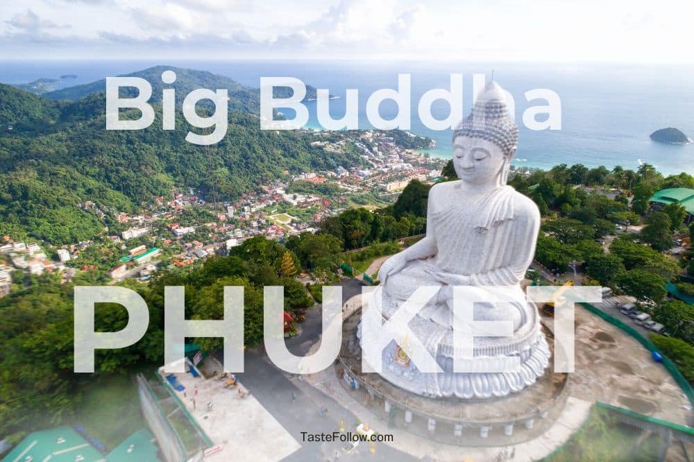 Aerial view of Big Buddha Phuket statue located on a lush green hill overlooking the sea and surrounding city. The massive white statue sits in a meditative pose. The words "Big Buddha" and "PHUKET" are prominently overlaid on the image. The sky is partly cloudy.