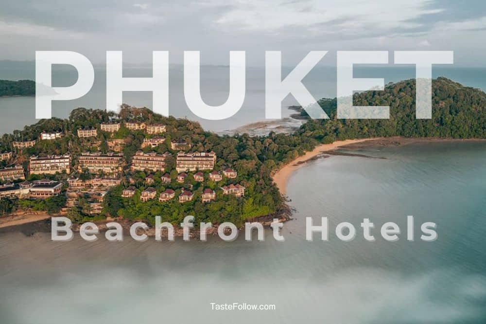 Aerial view of a tropical beachfront area in Phuket featuring lush greenery and multiple luxury beachfront resorts. The sea surrounds the peninsula, with sandy beaches visible on both sides. Large text overlay reads "PHUKET Beachfront Hotels" with a website "TasteFollow.com" at the bottom.